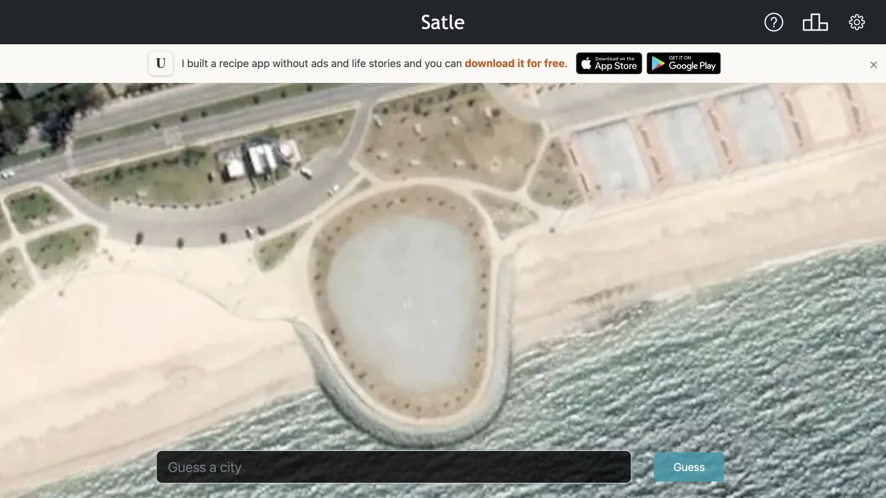 Satle — daily satellite city image with the city-entry field and guess control